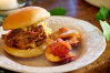 These pulled pork sandwiches are served overstuffed with tender pulled pork simmered in smoky barbecue sauce. Each Carolina pulled pork sandwich is topped with a dollop of creamy coleslaw seasoned with a tangy-sweet Carolina-style honey mustard barbecue sauce.