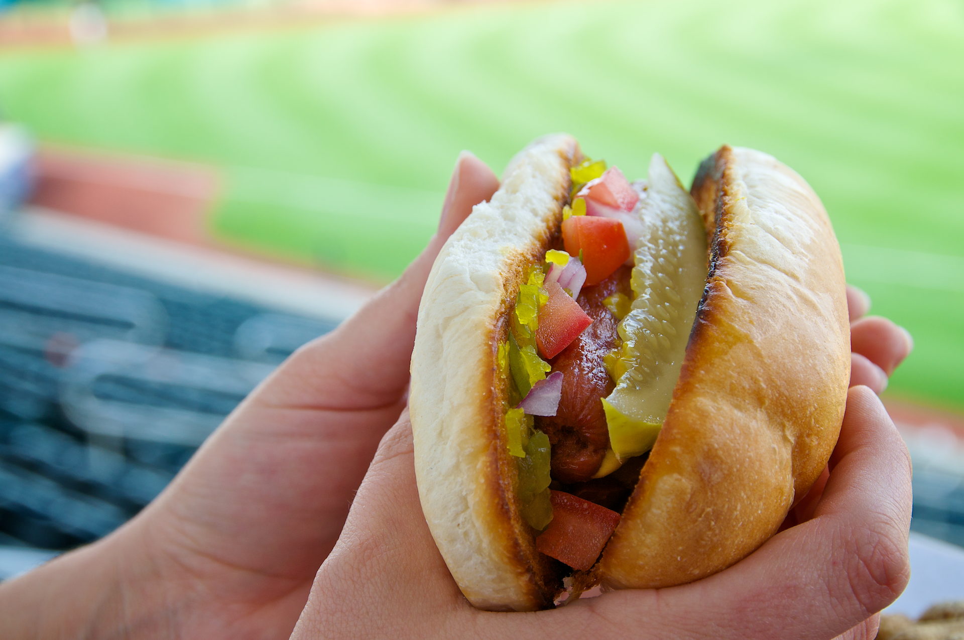 Classic hot dogs from the Windy City piled high with sweet pickle relish, tomatoes, onions, mustard, and a pickle spear.
