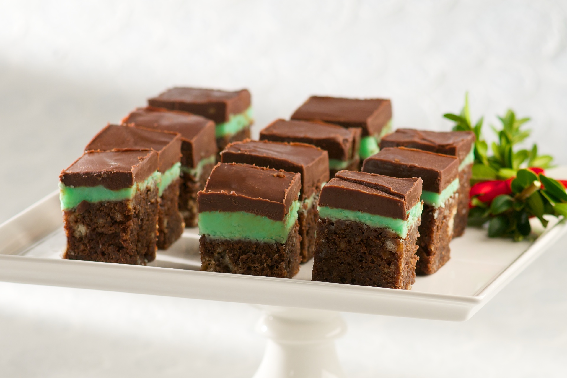 These bars are great at the holidays with their festive green mint layer. They have a cake-like first layer, then mint, then dark chocolate on top. Keep these refrigerated or frozen until about an hour before serving.