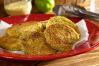This hearty side dish features thick slices of fresh green tomatoes dipped into egg, flour and cornmeal mixture and pan fried until golden.