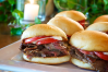 This delicious mini-sandwich platter for entertaining features tender slow smoked beef brisket, creamy horseradish sauce, and ripe sliced tomatoes served on buttery toasted mini rolls.