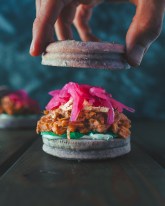 This sandwich features the meaty jackfruit, garlic aioli, pickled red onions, and vegan pepper jack cheese on a black goji berry gluten-free bun. This sandwich is irresistible and packed full of explosive flavor!