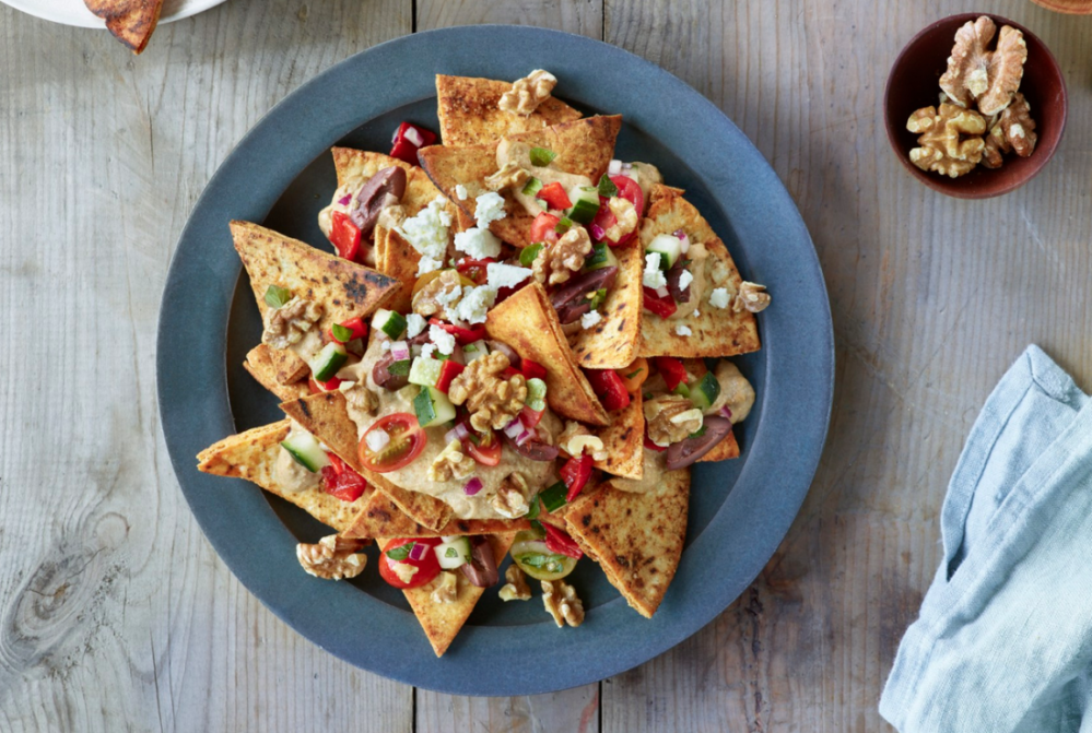 Add some Mediterranean flair to your nachos with the addition of cucumber, kalamata olives, red peppers, tomatoes and oregano.