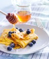 Photo of plated blueberry blintzes with honey, taken for the National Honey Board.