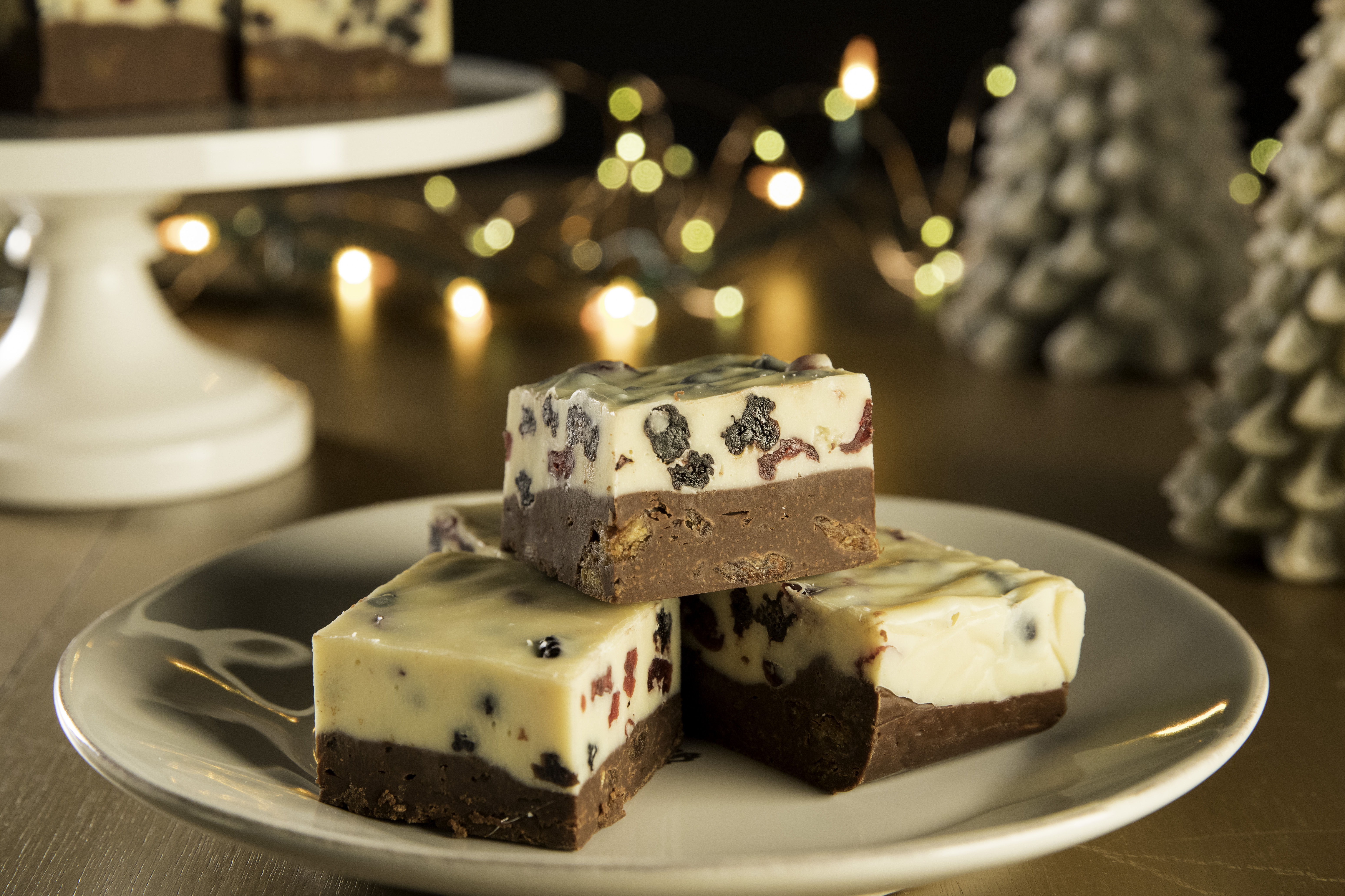 Here’s a way to plus up your fudge for the season, both in looks and in flavor. It’s a double layered fudge with milk chocolate on the bottom and white chocolate on top, and both have the surprise of dried fruit inside. As one tester noted, “It’s what fruit cake would taste like if it was good!