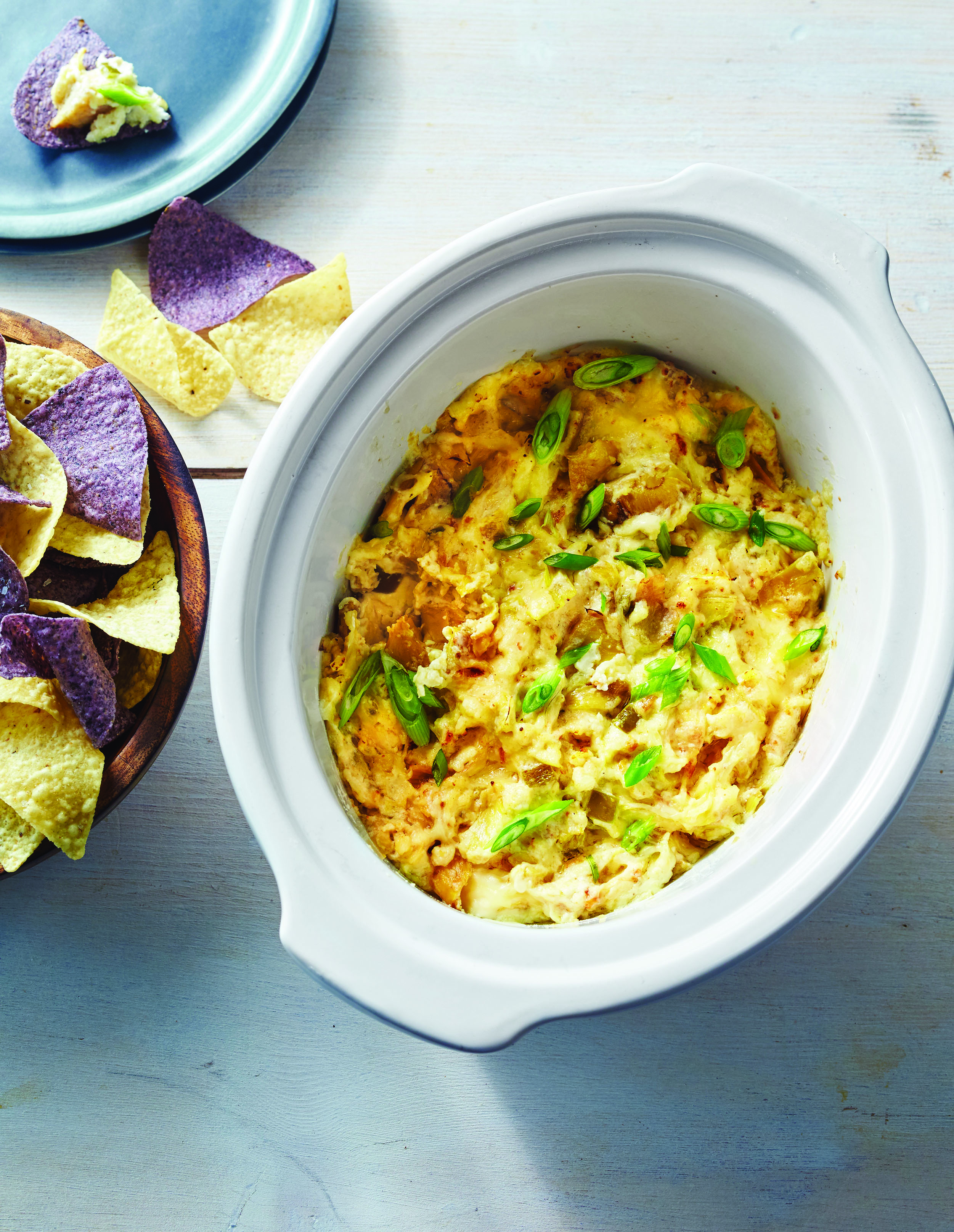 This artichoke dip is a quick and easy make in the crock pot, made with a blend of four kinds of cheese and the classic ingredients you crave.