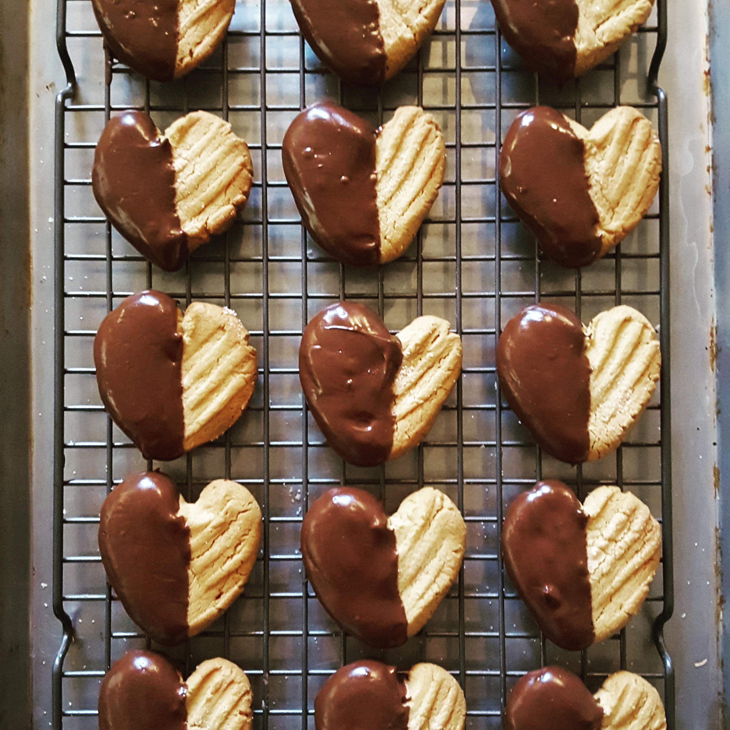 The pairing of peanut butter and chocolate has been one of America’s favorite flavor combinations for years, and my Chocolate Dipped Peanut Butter Cookies are a special Valentine’s Day treat you can share with those that you love…or make just for yourself!