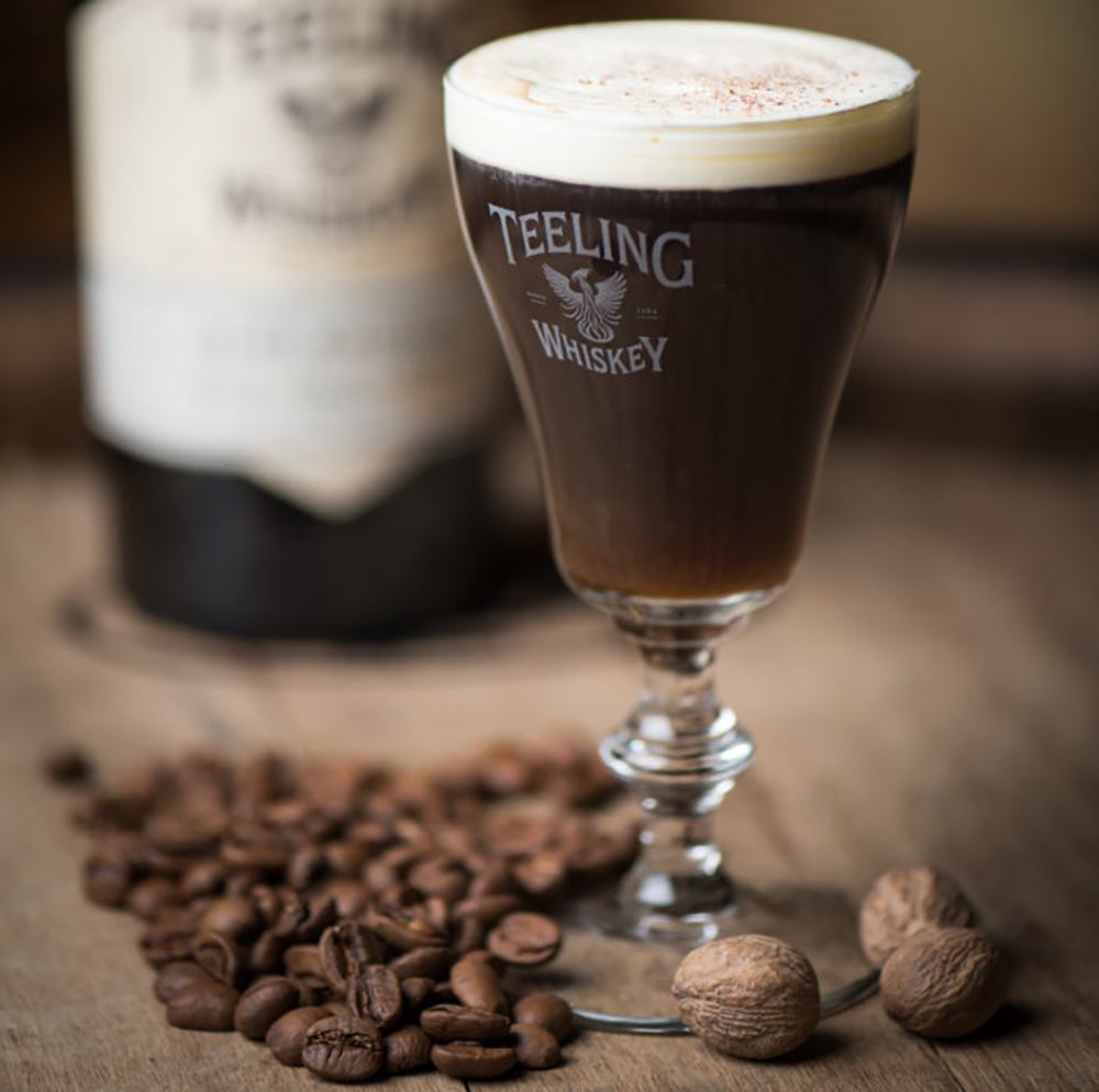 A take on the traditional Irish Coffee, this Teeling Whiskey Irish Coffee is made with Teeling Small Batch Whiskey, orange zested cream and a house-made Spiced Stout Syrup.