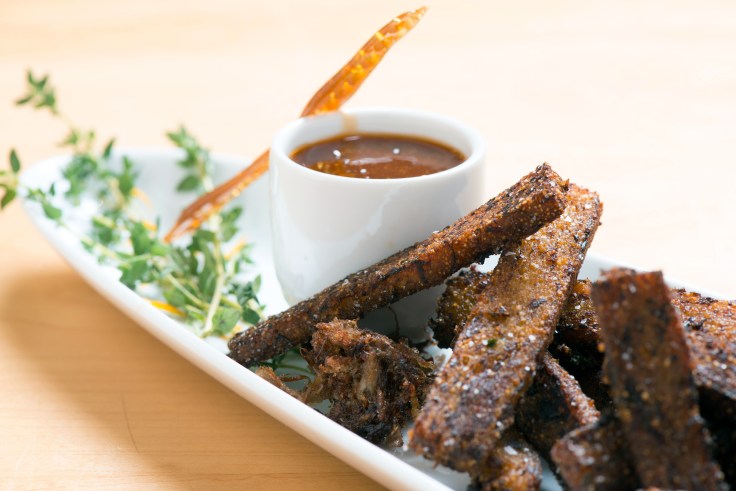 These smokey pork 'fries' are easy-to-eat, hand-held pork shoulder bites made with apple cider, dijon mustard, buckwheat honey, herbs, spices, and cornmeal.