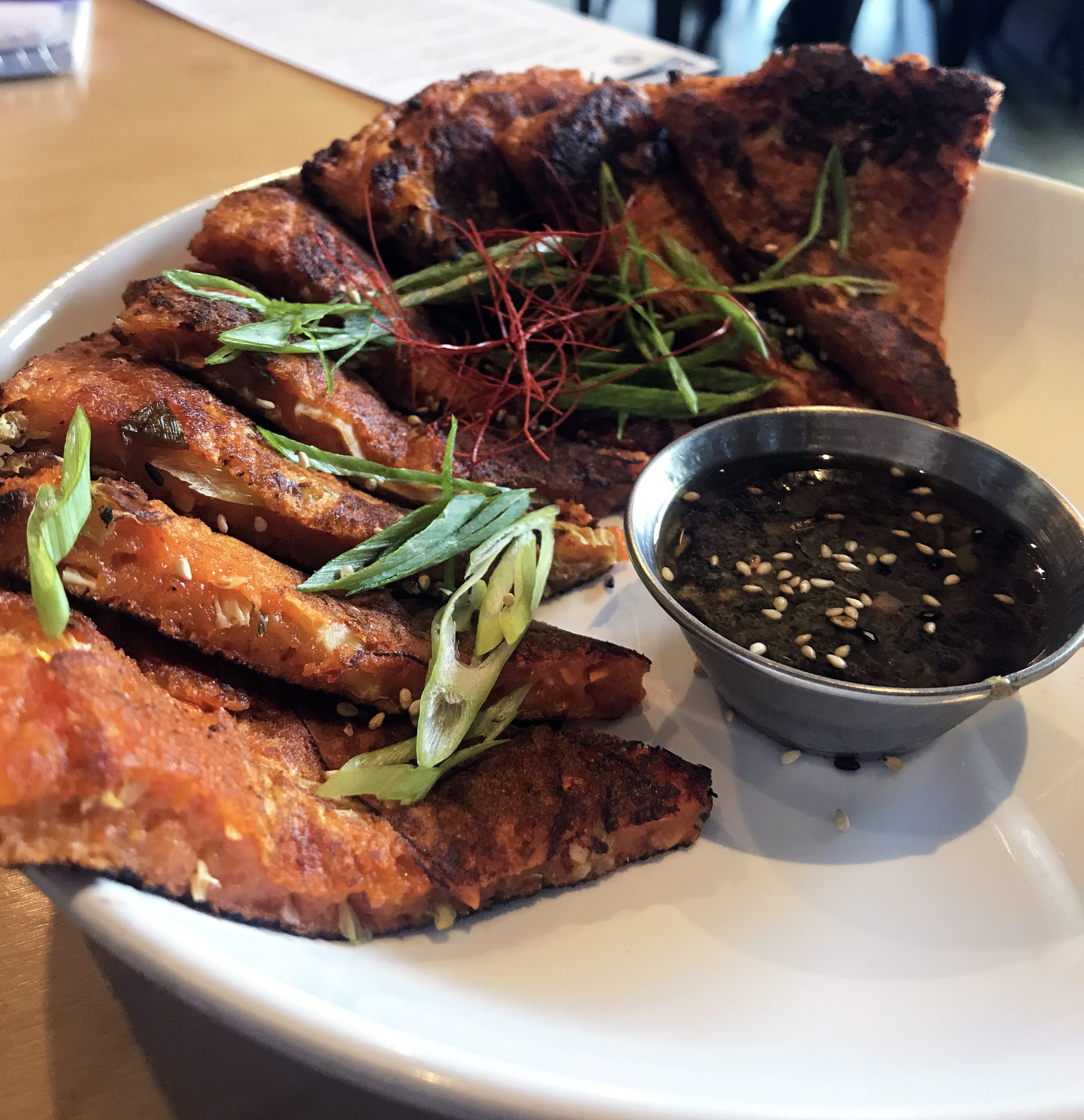 We had the pleasure of tasting a variety of dishes, complimentary of HOMES, including the chicken wings; both the Sichuan dry rub and Korean BBQ; a Kimchi Flight, which is a trio of seasonal house kimchi; a daily special of Kimchi Pancakes.