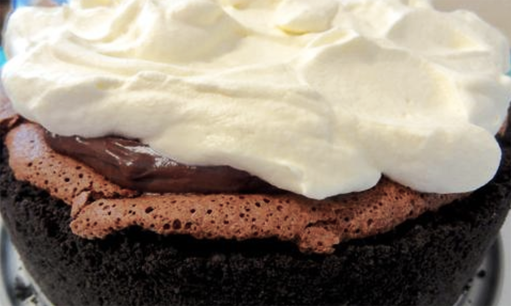 This delicious recipe for a Mississippi Mud Pie Cake is adapted from Matt Lewis' delightful cookbook Baked Exlorations. It's a chocolate-lover's dream crafted by Lewis who is also co-founder of the Brooklyn bakery BAKED. It features a chocolate-cookie crust, topped with a flourless chocolate cake,  filled with chocolate pudding and topped with whipped cream.