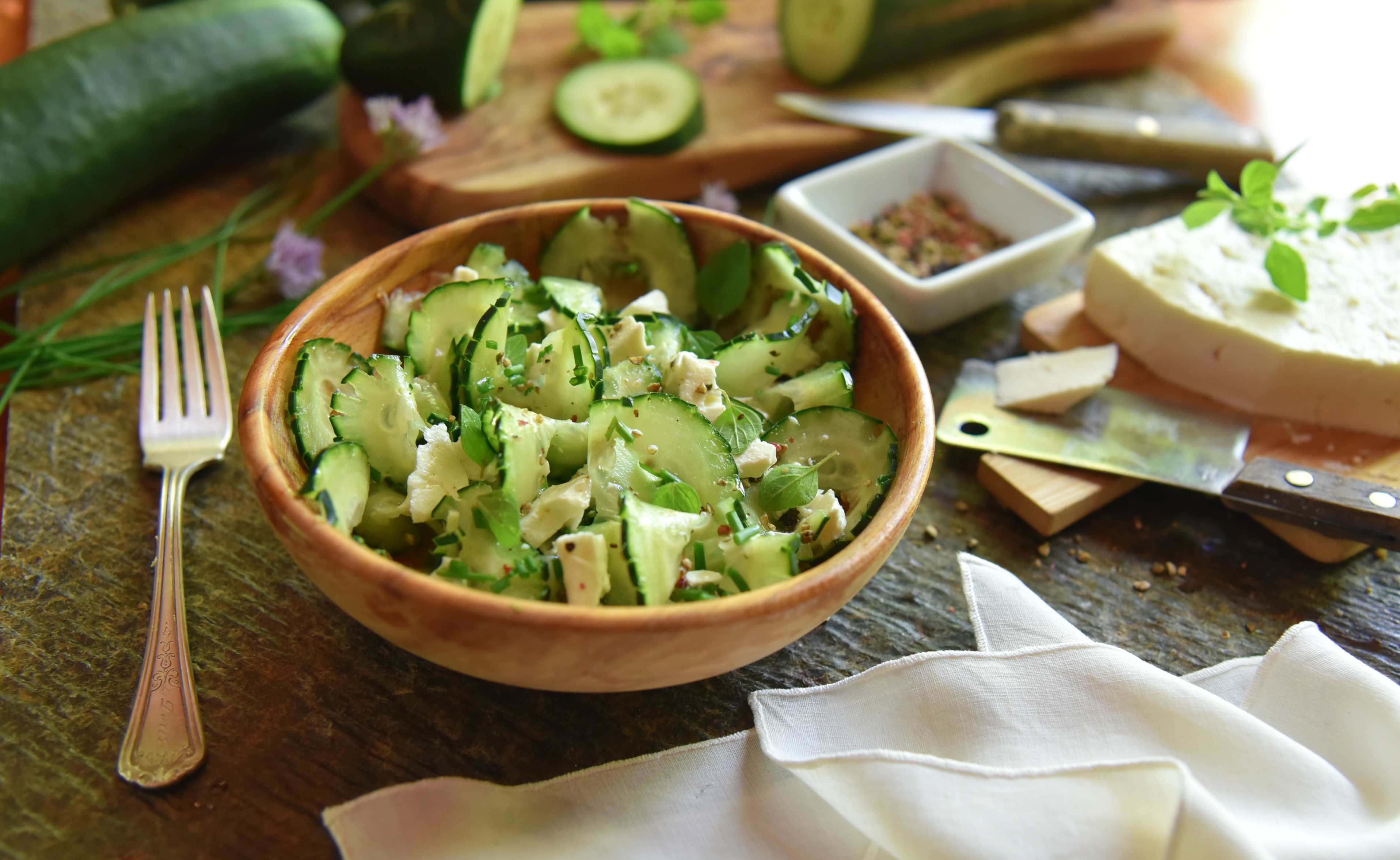 A refreshing, fresh, cucumber salad made with chives, feta cheese, avocado oil, and freshly-cracked peppercorns!
