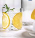 Shake first two ingredients well with ice. Strain into a rocks glass over fresh ice and stir in club soda. Top with juice from a squeezed lemon. Garnish with lemon wheel and rosemary sprig.