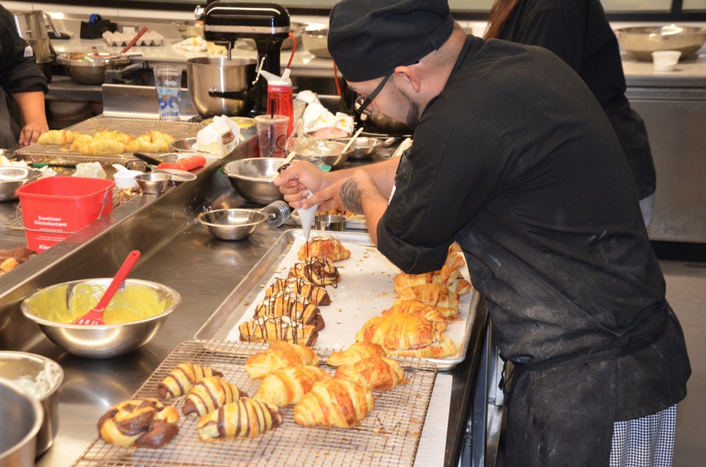 A pastry student applying the finishing touches during class at Brightwater, A Center for the Study of Food. 