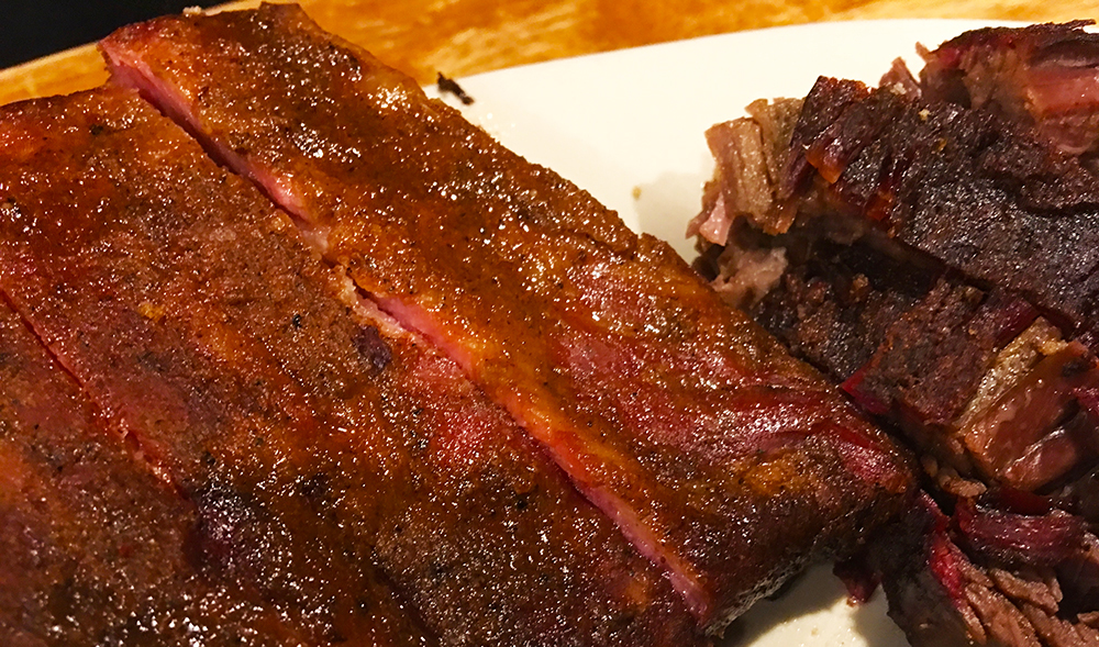 A plate of barbecue ribs, covered with delicious barbecue sauce from Rick's Smokehouse in Terre Haute, Indiana.