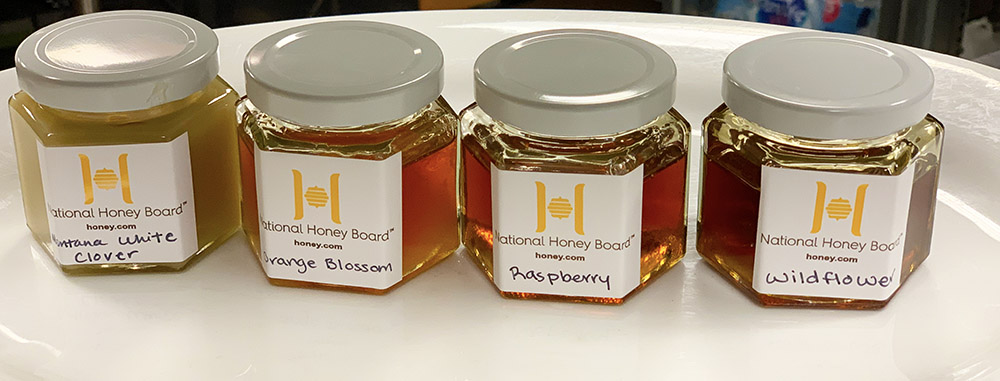 An assortment of jars, each filled with new varietal flavors of honey being developed by the National Honey Board. 
