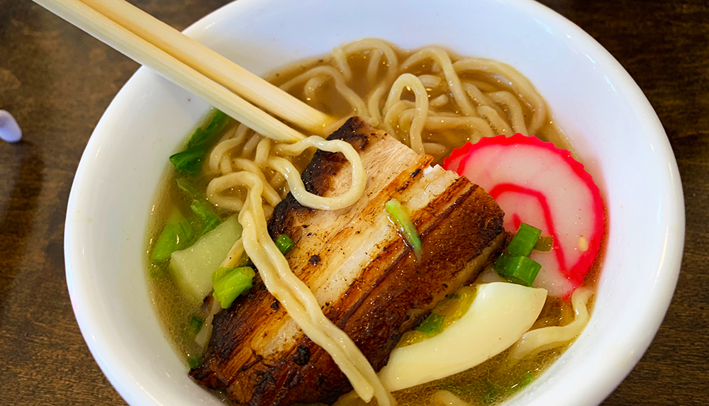 The broth bowl is originally the creation of Hawaiian immigrants who worked in the plantations and piled whatever they could find into their soup—fish, noodles, and whatever they could find in the house or garden.
