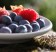 A plate of fresh raspberries and blueberries, two superfoods included in the Diabetes Superfoods Cookbook. 