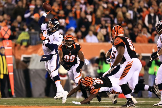 Denver Broncos quarterback Peyton Manning (18) throws a pass while being pressured by the Cincinnati Bengals defense. (Andrew Weber-USA TODAY Sports)
