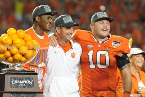 Clemson head coach Dabo Swinney celebrates with linebacker Ben Boulware (10) and quarterback Deshaun Watson (4) after defeating the Oklahoma Sooners in the 2015 CFP semifinal at the Orange Bowl at Sun Life Stadium. Clemson won 37-17. Mandatory Credit: Robert Duyos-USA TODAY Sports
