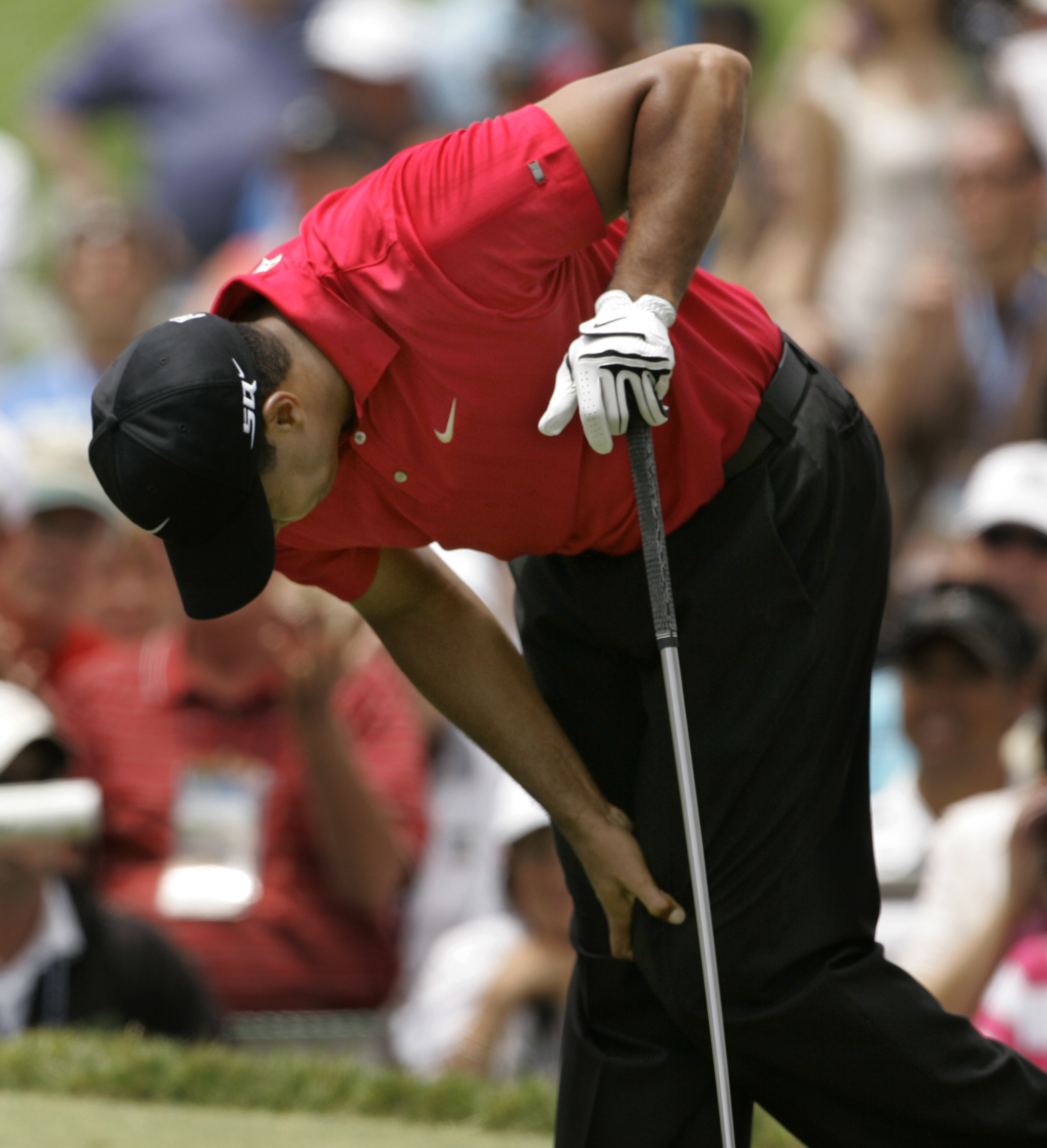Tiger Woods holds his left knee after teeing off on the second hole during the fourth round of the 2008 U.S. Open at Torrey Pines in San Diego. Woods had reconstructive surgery on his left knee Tuesday, June 24, 2008, in Utah to repair a torn ligament. Woods went on to win in a playoff over Rocco Mediate.
