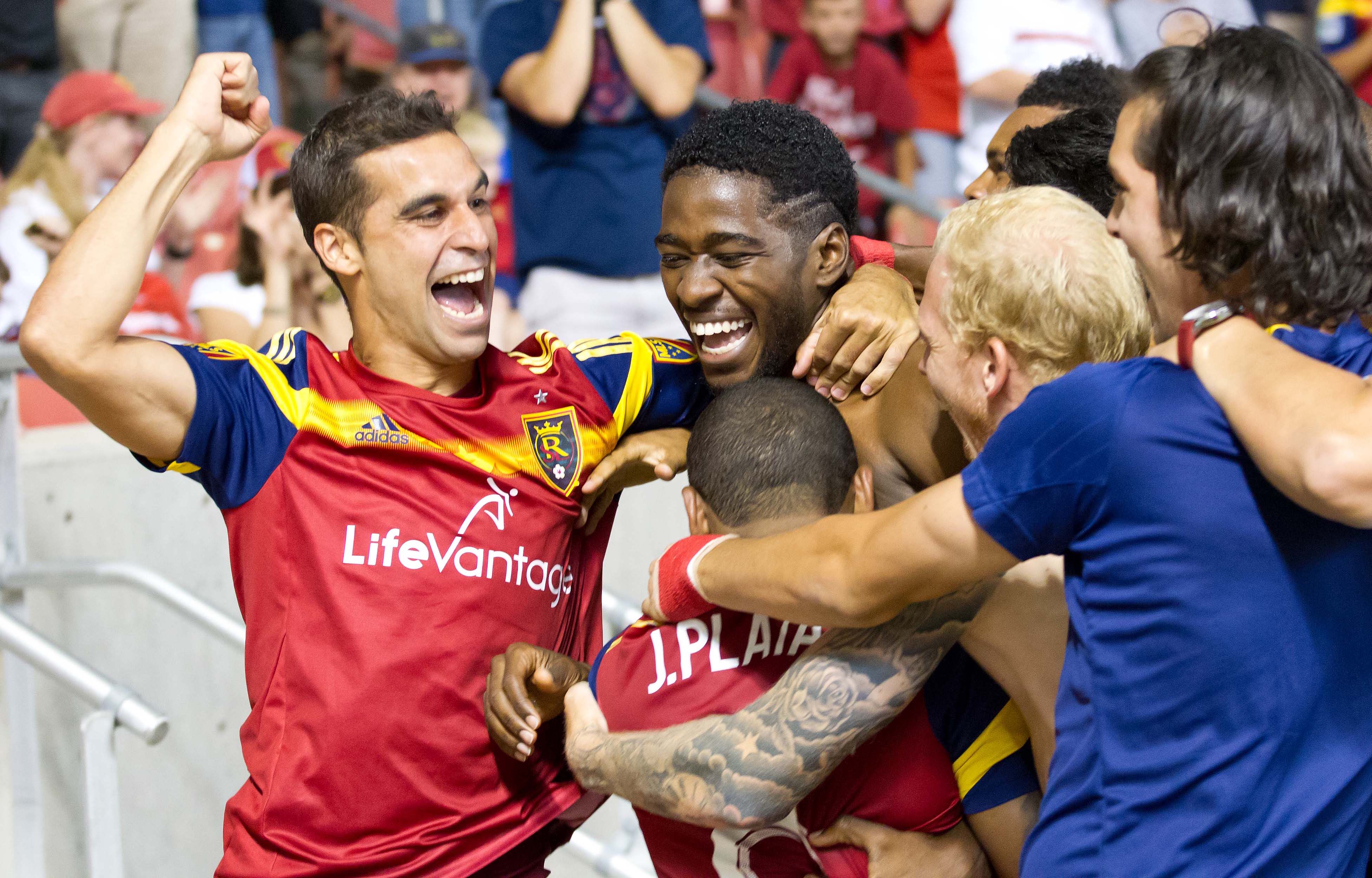 Jun 21, 2015; Sandy, UT, USA; Real Salt Lake forward Sebastian Jaime (L) and forward Olmes Garcia (center) and teammates celebrate a goal by Garcia during stoppage time at the end of the second half against Sporting KC at Rio Tinto Stadium. Real Salt Lake won 2-1. Mandatory Credit: Russ Isabella-USA TODAY Sports