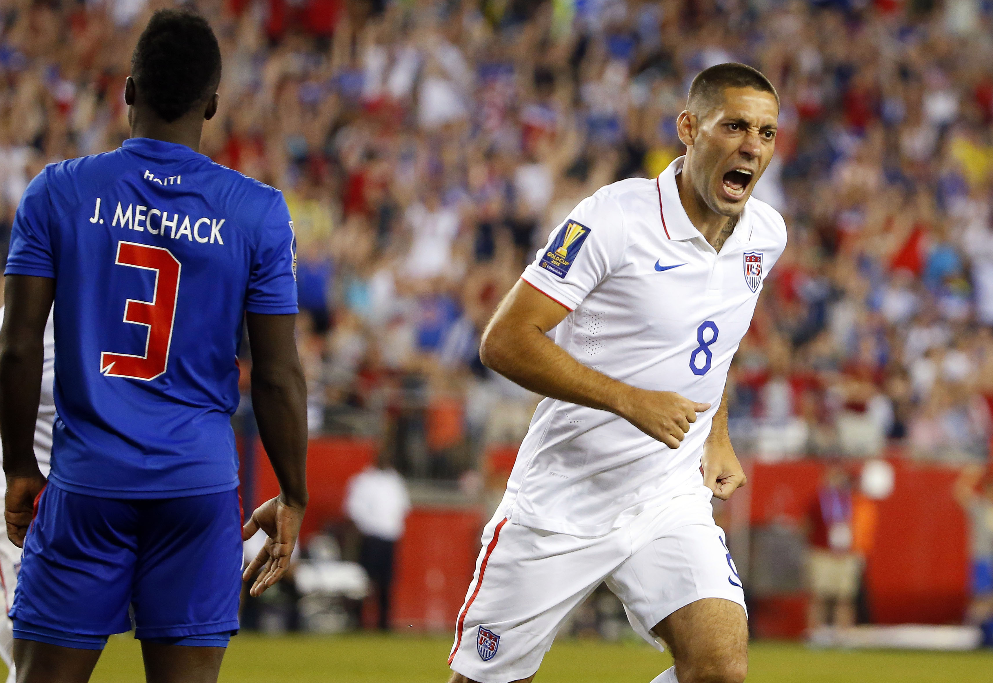 Jul 10, 2015; Foxborough, MA, USA; United States forward Clint Dempsey (8) celebrates his goal behind Haiti defender Mechack Jerome (3) during the second half of CONCACAF Gold Cup group play at Gillette Stadium. Mandatory Credit: Winslow Townson-USA TODAY Sports