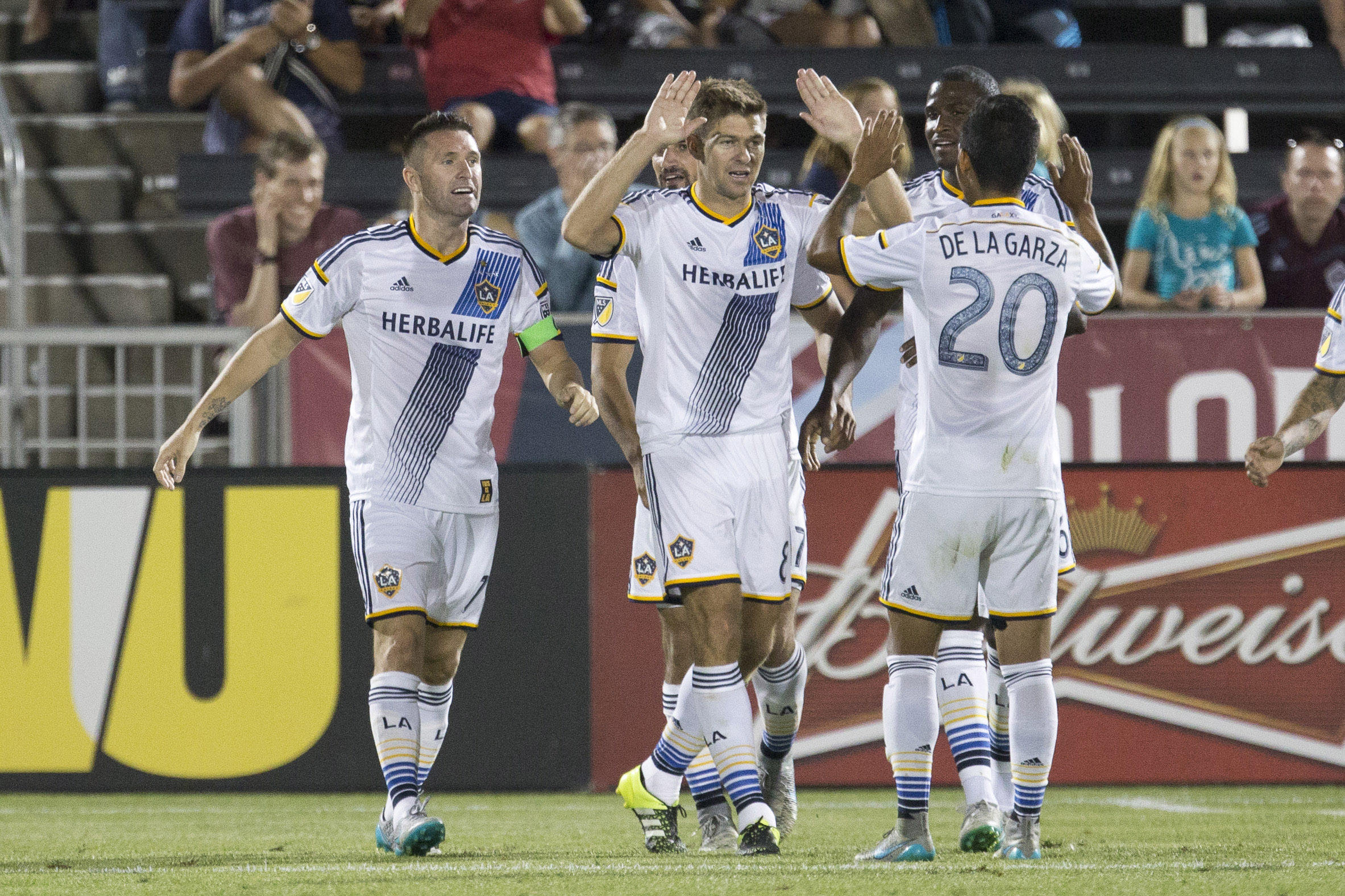 Aug 1, 2015; Commerce City, CO, USA; Los Angeles Galaxy midfielder Steven Gerrard (8) and defender A.J. DeLaGarza (20) celebrate the goal of forward Robbie Keane (7) in the second half against the Colorado Rapids at Dick's Sporting Goods Park. Mandatory Credit: Isaiah J. Downing-USA TODAY Sports