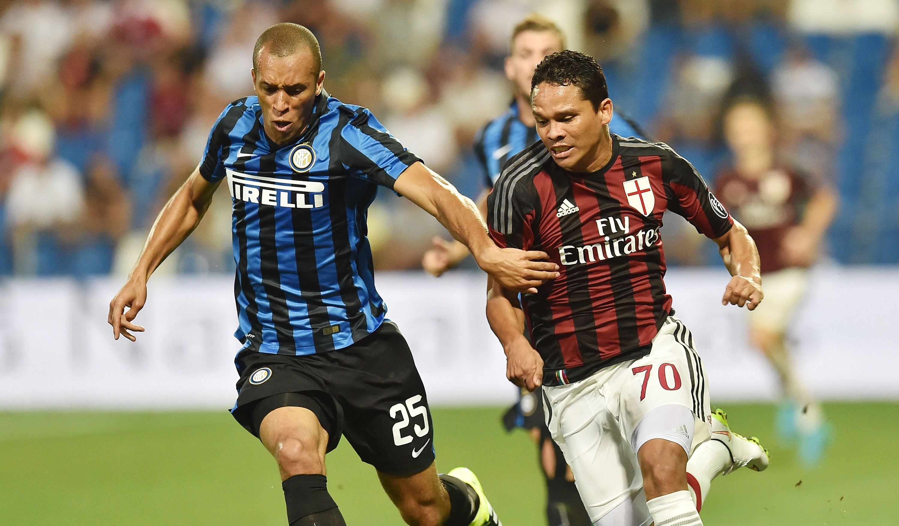 REGGIO NELL'EMILIA, ITALY - AUGUST 12: Joao Miranda of Internazionale and Carlos Bacca Ahumada of Milan in action during the TIM pre-season tournament match between AC Milan and FC Internazionale at Mapei Stadium - Città del Tricolore on August 12, 2015 in Reggio nell'Emilia, Italy. (Photo by Giuseppe Bellini/Getty Images)