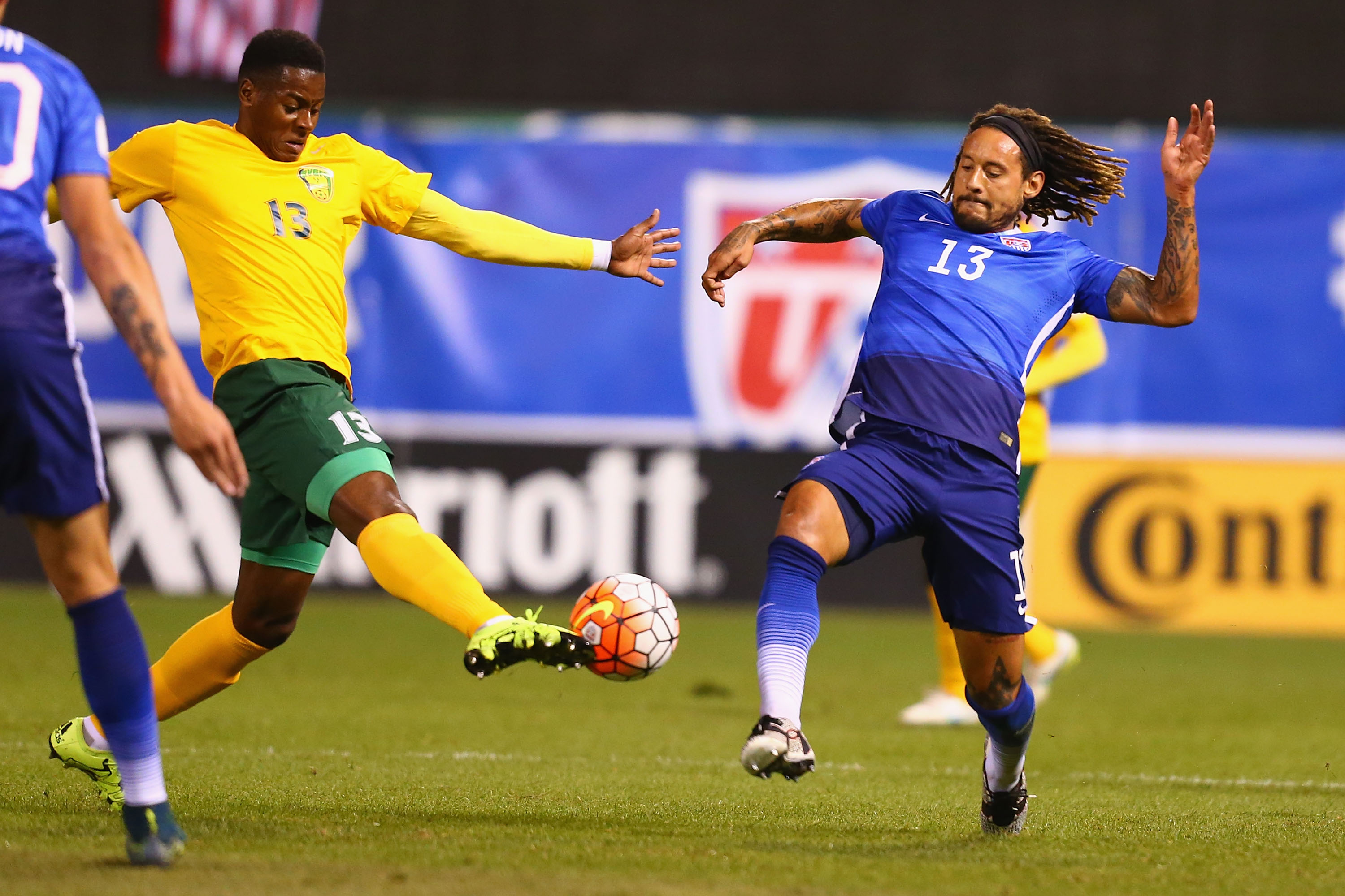 ST. LOUIS, MO - NOVEMBER 13: Gavin James #13 of St. Vincent and the Grenadines and Jermaine Jones #13 of the United States compete for a loose ball during a World Cup qualifying match at Busch Stadium on November 13, 2014 in St. Louis, Missouri. (Photo by Dilip Vishwanat/Getty Images)