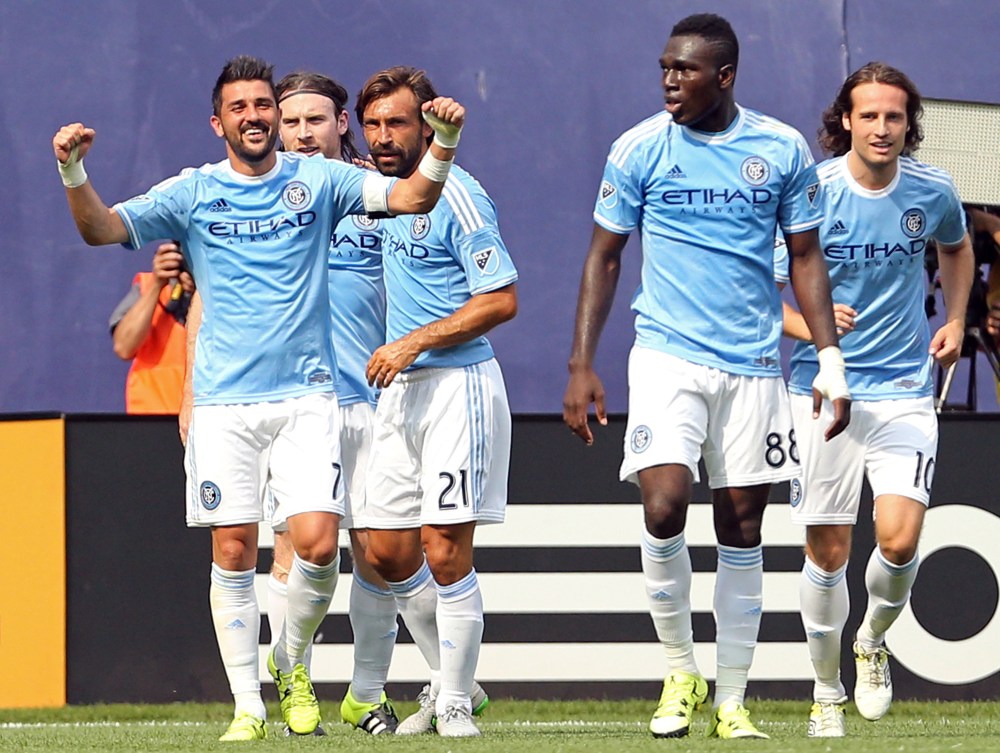Jul 26, 2015; New York, NY, USA; New York City FC forward David Villa (7) celebrates with teammates after a goal against the Orlando City FC during the second half of a soccer match at Yankee Stadium. The New York City FC won 5-3. Mandatory Credit: Adam Hunger-USA TODAY Sports