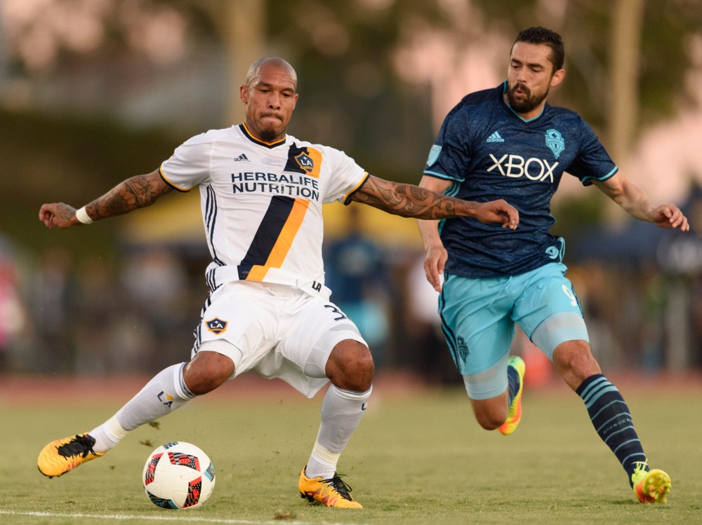 Jul 20, 2016; Los Angeles, CA, USA; LA Galaxy midfielder Nigel de Jong (34) moves the ball defended by Seattle Sounders FC forward Herculez Gomez (9) during the first half at StubHub Center. Mandatory Credit: Kelvin Kuo-USA TODAY Sports