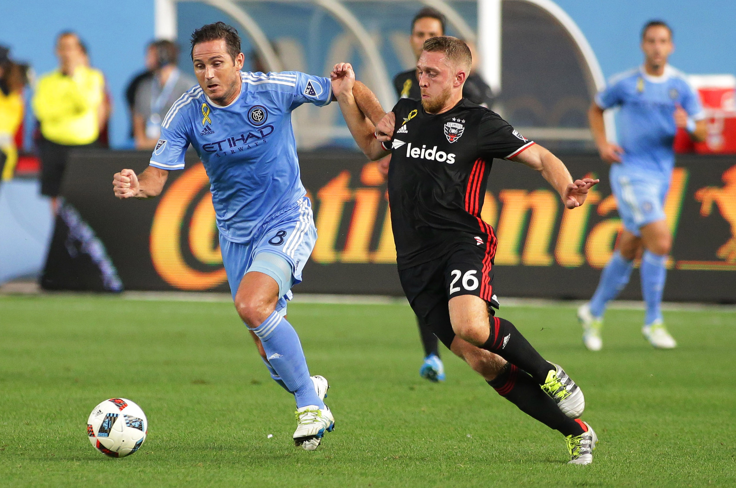 Sep 1, 2016; New York, NY, USA; NYCFC midfielder Frank Lampard (8) and D.C. United midfielder Rob Vincent (26) pursue a loose ball during the first half at Yankee Stadium. Mandatory Credit: Andy Marlin-USA TODAY Sports