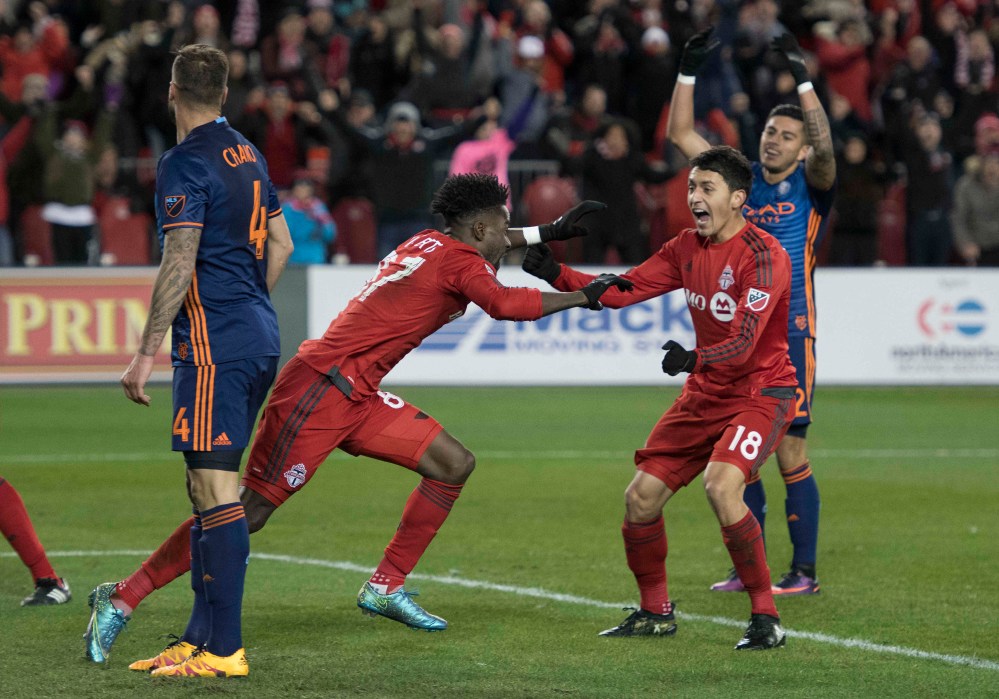 Toronto FC forward Tosaint Ricketts (87) celebrates scoring a goal with Toronto FC midfielder Marco Delgado (18) during the second half of the Conference Semifinals against New York City FC at BMO Field. Toronto FC won 2-0. Mandatory Credit: Nick Turchiaro-USA TODAY Sports