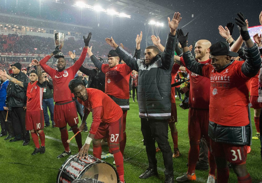 Nov 30, 2016; Toronto, Ontario, CAN; Toronto FC forward Jozy Altidore (17) leads a cheer with the Eastern Conference trophy after winning against the Montreal Impact at BMO Field. Toronto FC won 5-2. Mandatory Credit: Nick Turchiaro-USA TODAY Sports