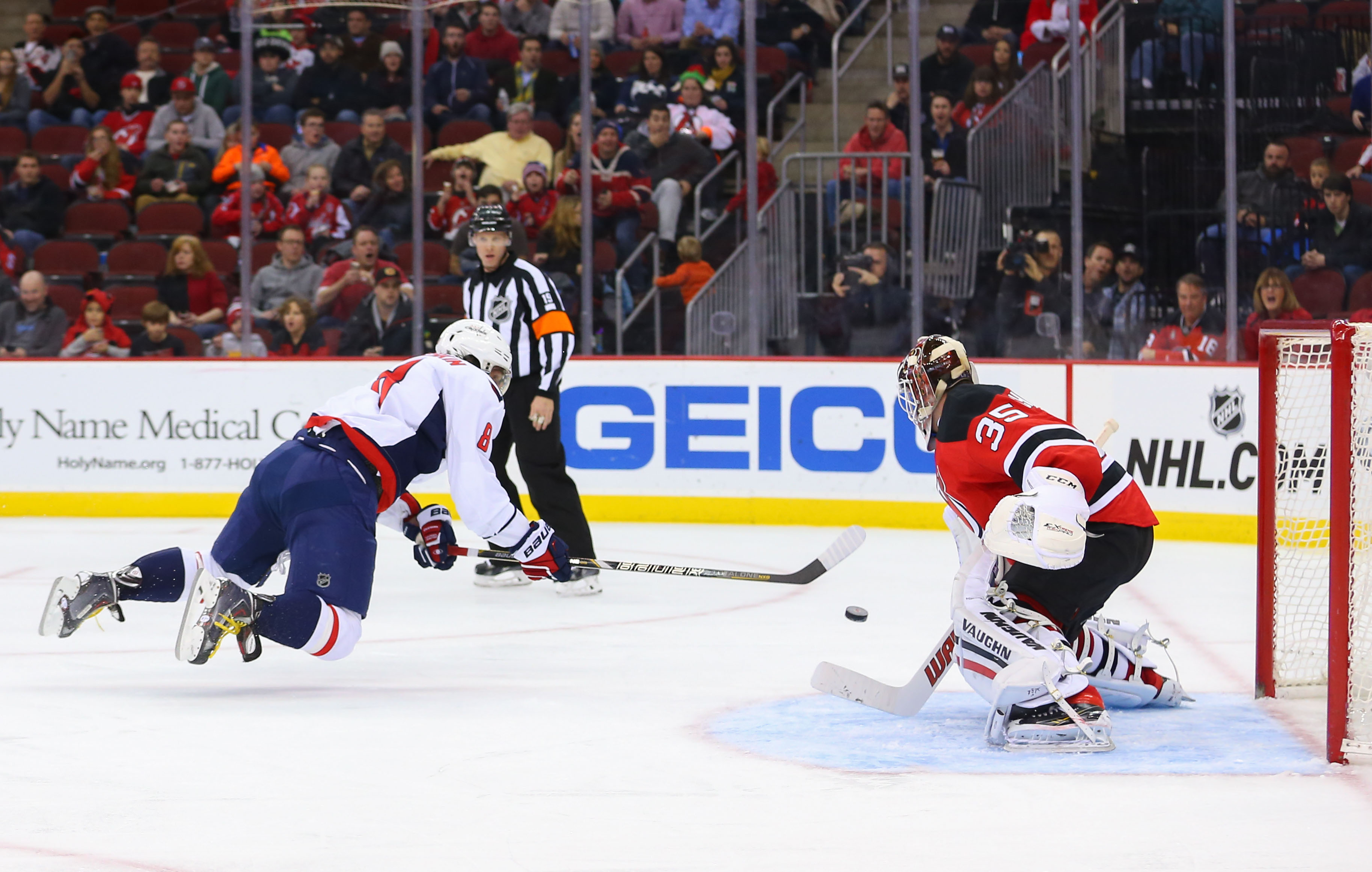 Alex Ovechkin scores past Cory Schneider while airborne. (Ed Mulholland, USA TODAY Sports)