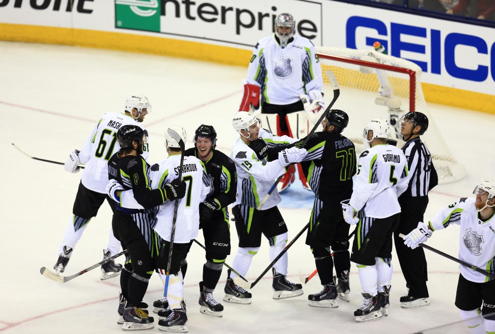 Members of Team Toews and Team Foligno grab onto each other..for hugs! (Photo by USA TODAY Sports Images)
