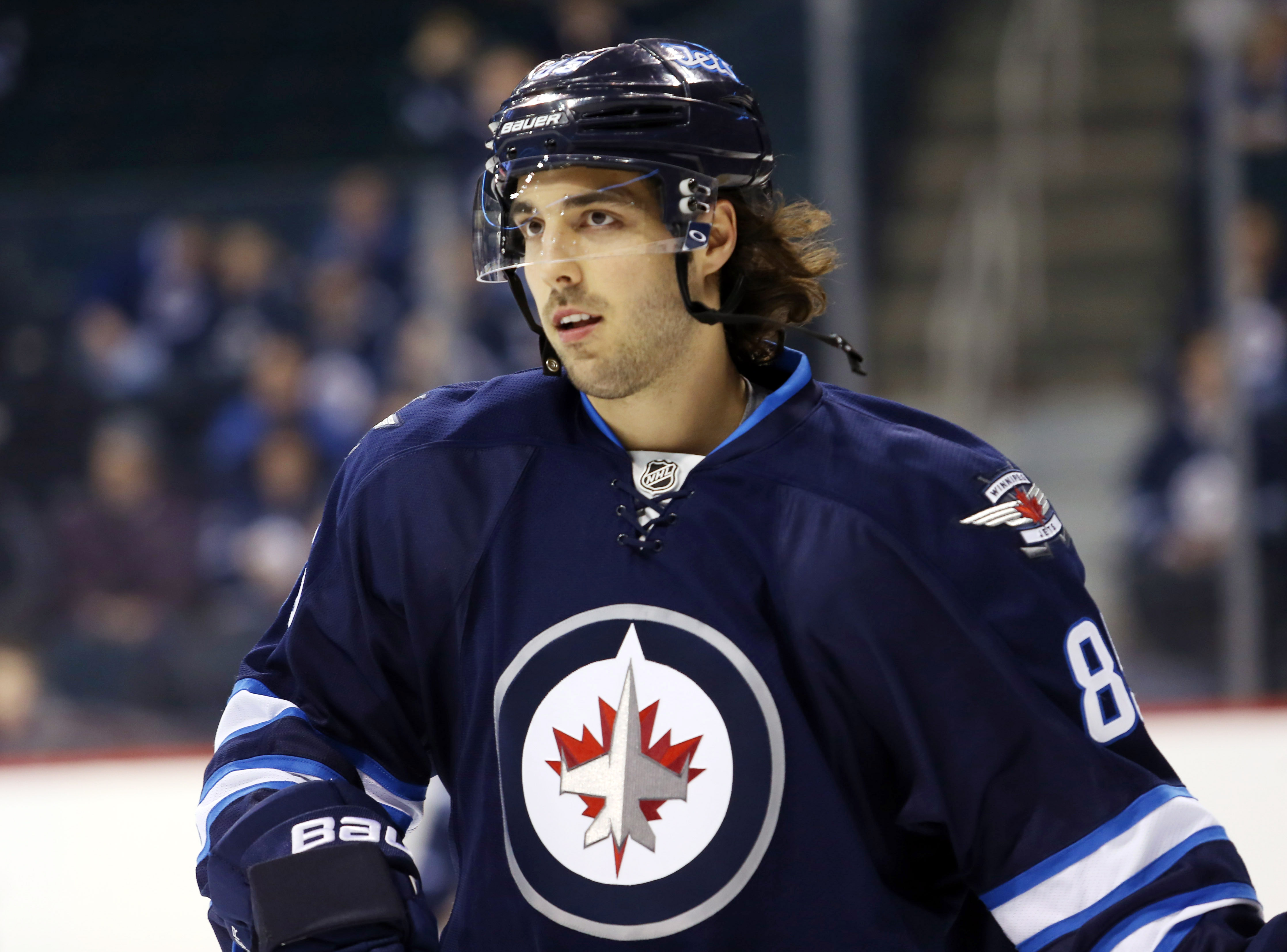 Winnipeg Jets' Blake Wheeler, left, and Bryan Little (18) fight