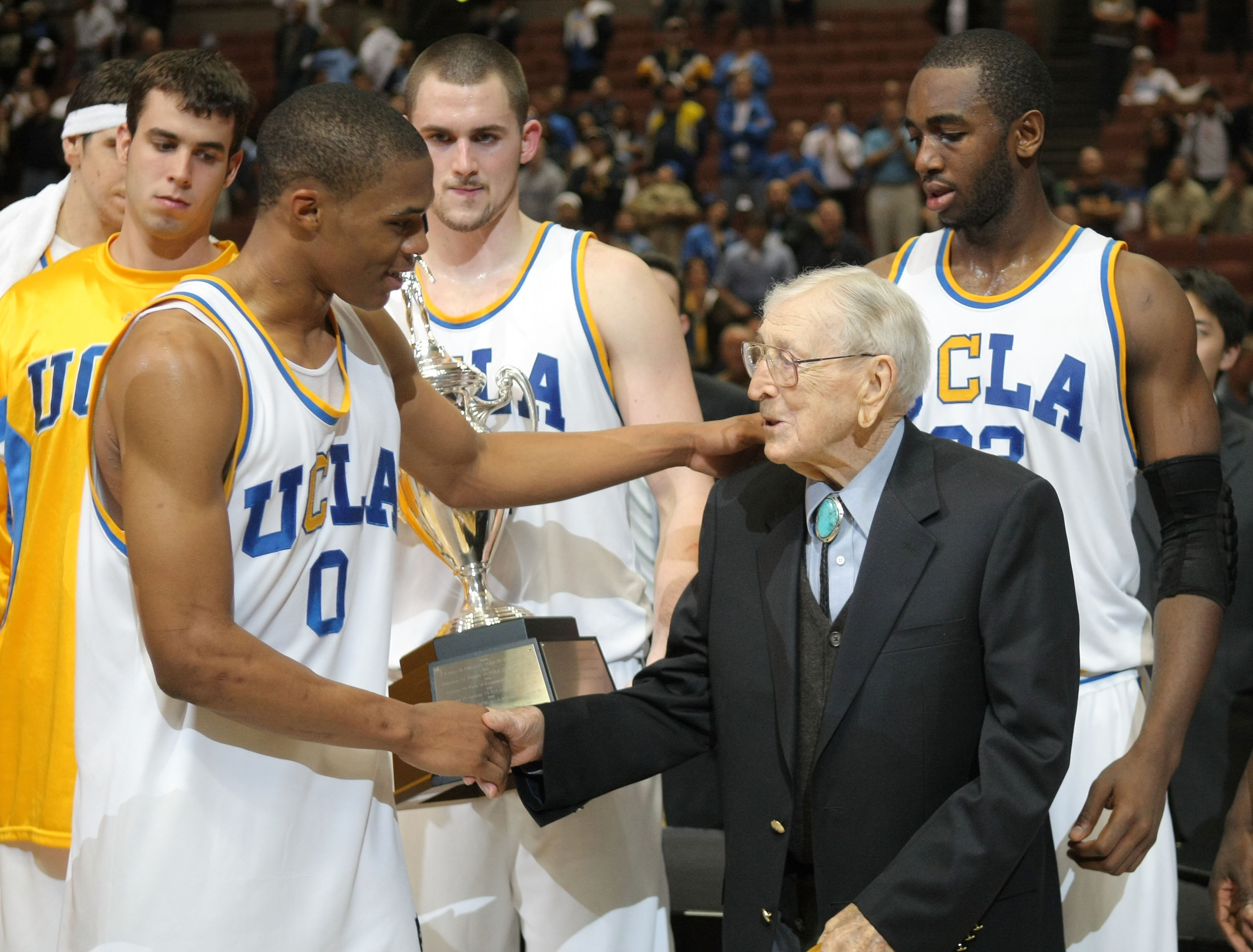 Russell Westbrook shakes hands with John Wooden. (Getty Images)
