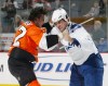 Andre Deveaux, right, fights Riley Cote in 2009. (Len Redkoles/NHLI via Getty Images)