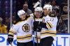 Torey Krug, left, and Reilly Smith, middle, celebrate a goal with Milan Lucic.  (Brad Penner, USA TODAY Sports)