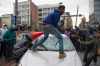 Demonstrators destroy the windshield of a Baltimore Police car as they protest the death Freddie Gray. (Photo via Jim Watson/Getty Images)