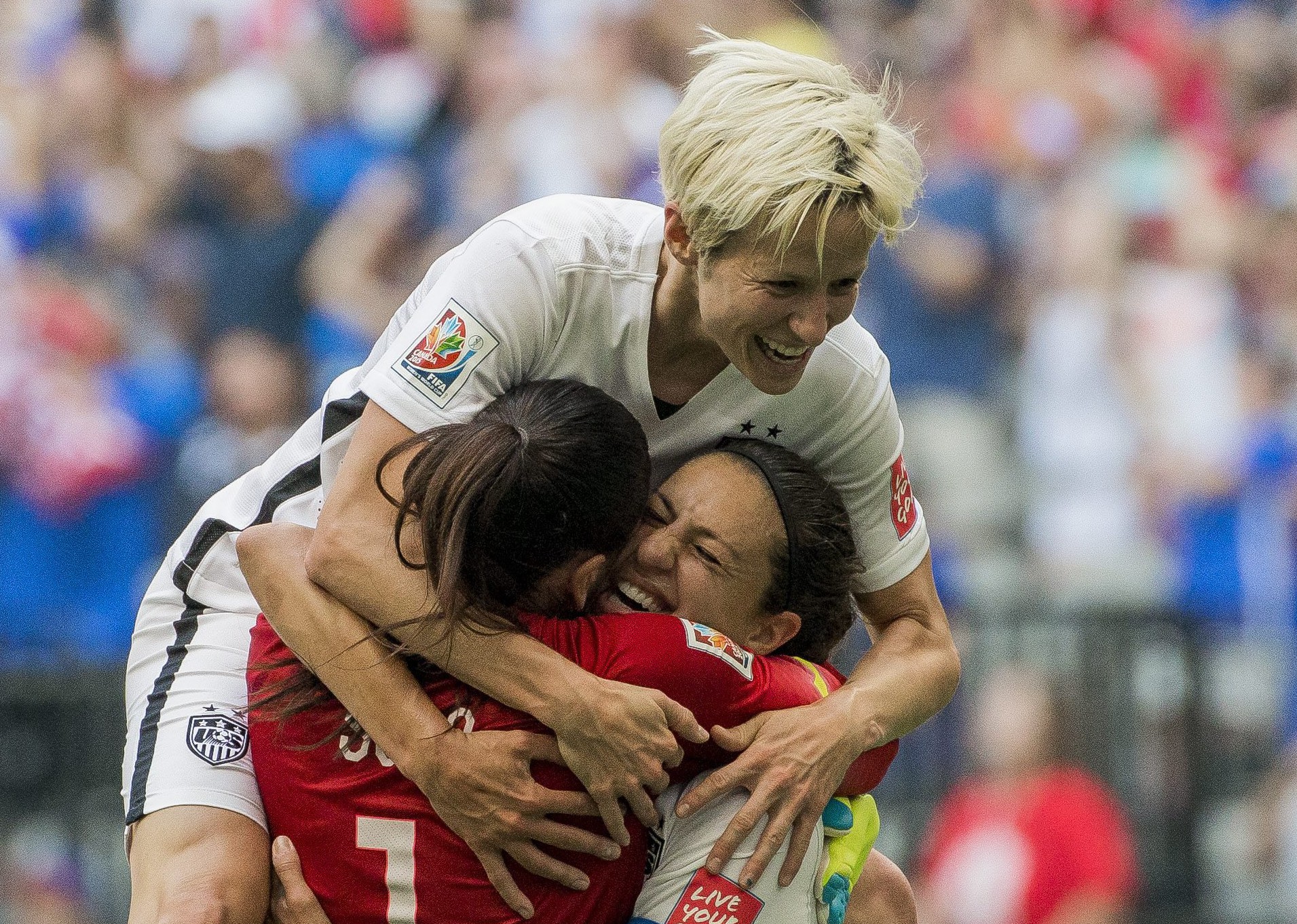 epa04833035 Carli Lloyd of the United States (10) celebrates her third goal of the first half with goalkeeper Hope Solo and Megan Rapinoe of the United States (top) during the FIFA Women's World Cup 2015 Final match between USA and Japan in Vancouver, Canada, 05 July 2015.  EPA/Bob Frid EDITORIAL USE ONLE, NOT USED IN ASSOCATION WITH ANY COMMERCUIAL ENTITY - IMAGES MUST NOT BE USED IN ANY FORM OF ALERT OR PUSH SERVICE OF ANY KIND INCLUDING VIA MOBILE ALERT SERVICES, DOWNLOADS TO MOBILE DEVICES OR MMS MESSAGING
