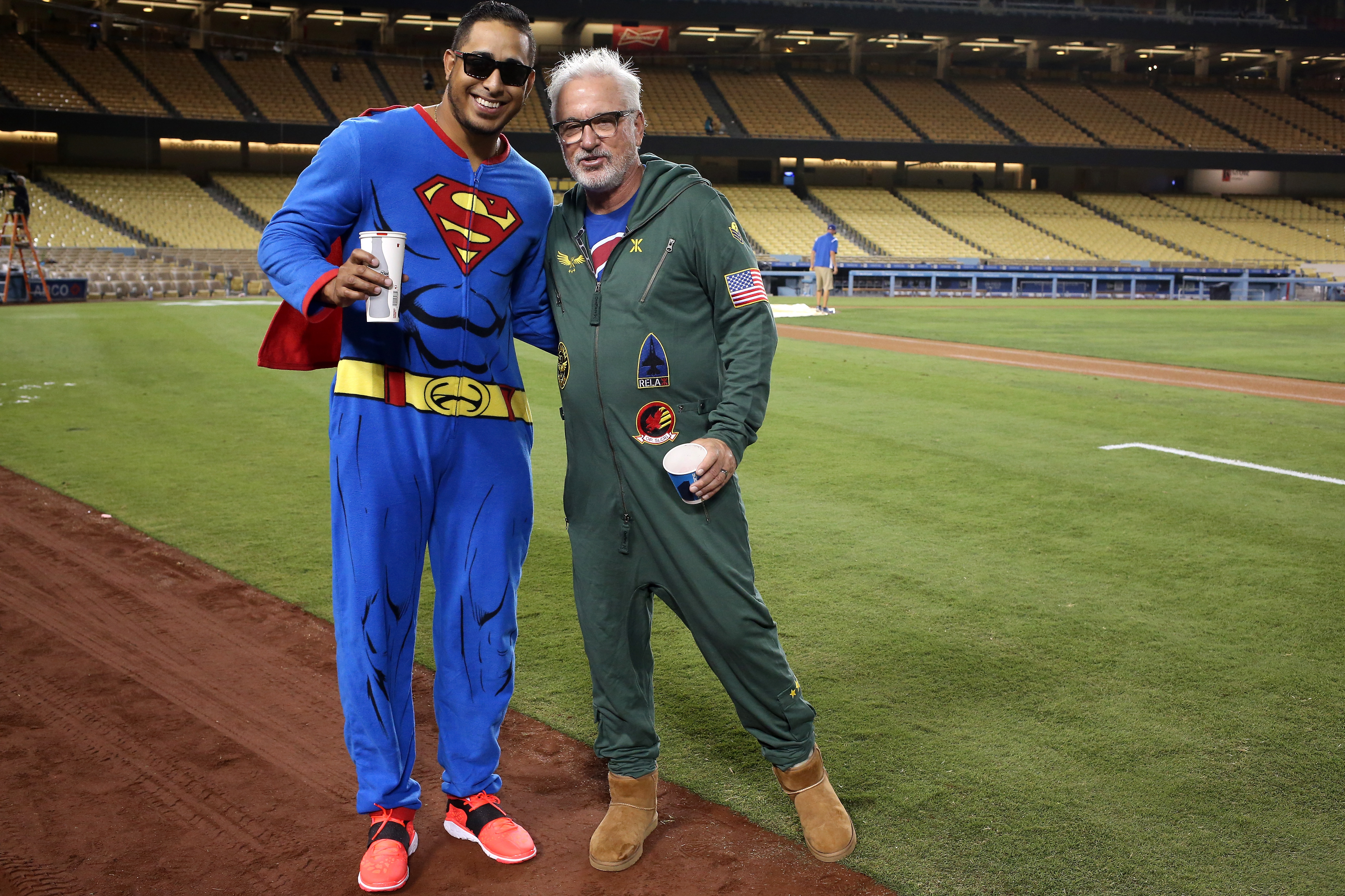 LOS ANGELES, CA - AUGUST 30:  Manager Joe Maddon (R) and pitcher Hector Rondon #56 of the Chicago Cubs pose for a photo as they wear pajamas as part of a team theme trip on their way out of town after the game against the Los Angeles Dodgers at Dodger Stadium on August 30, 2015 in Los Angeles, California.  The Cubs won 2-0.  (Photo by Stephen Dunn/Getty Images) ORG XMIT: 538593555 ORIG FILE ID: 486027048