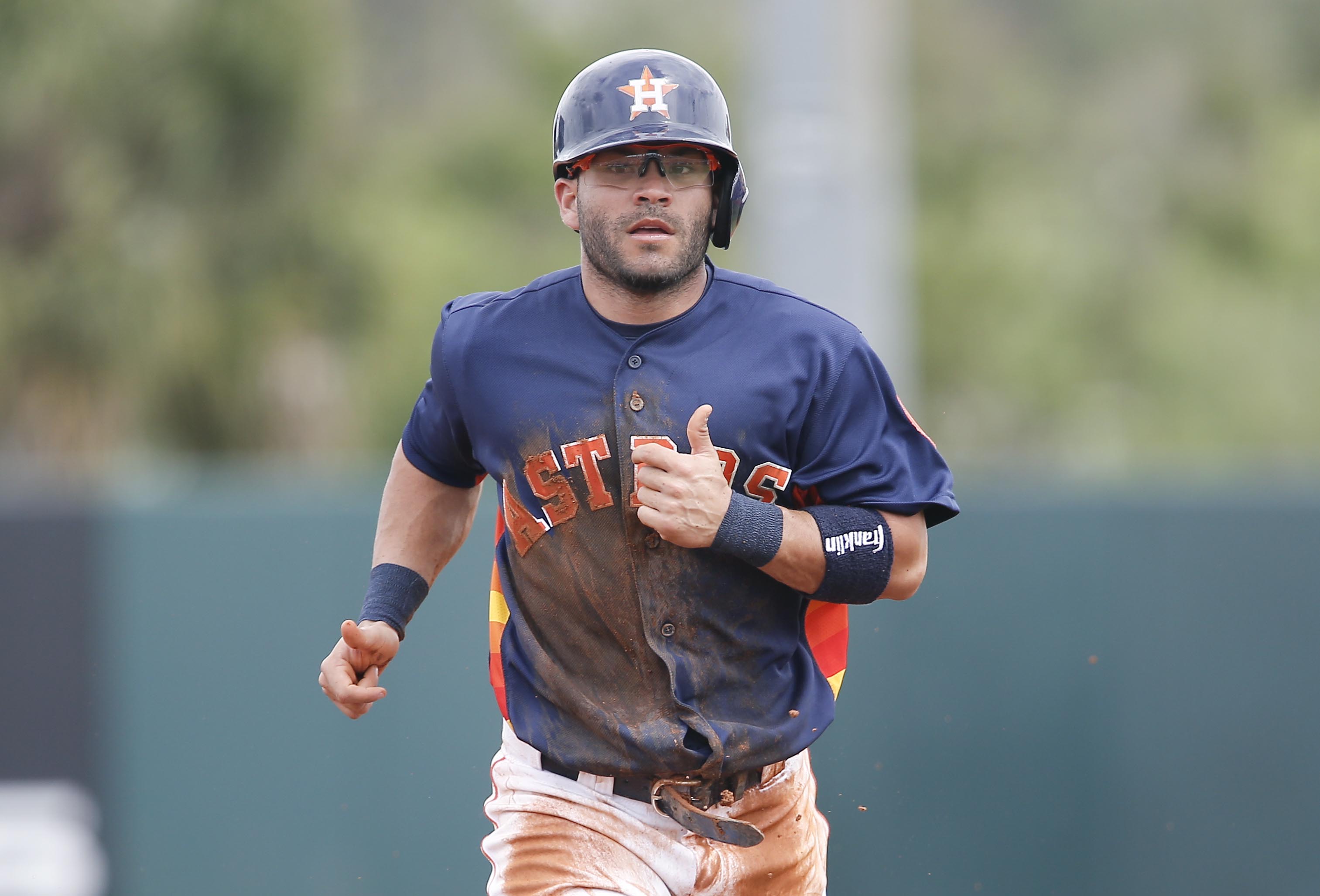 Jose Altuve of the Houston Astros jokes with teammates in the