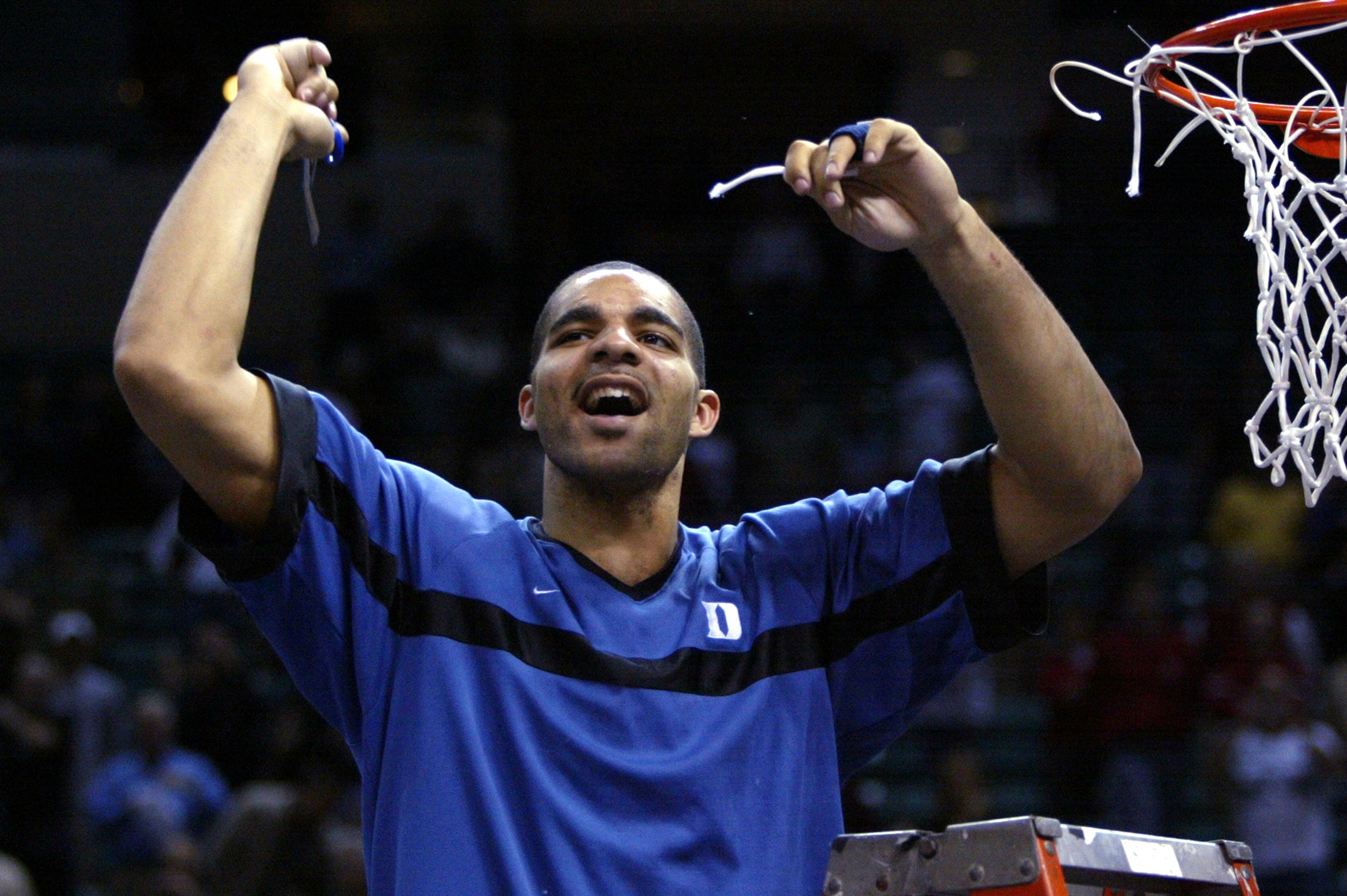 3/10/2002 -- Charlotte, N.C. -- ACC Basketball Tournament Championship Game -- Duke Blue Devils v. North Carolina State Wolfpack -- Duke's ACC Tournament MVP Carlos Boozer gives out a yell after taking his piece of the net after the Blue Devil's 91-61 victory over N.C. State in the ACC Tournament Championship game Sunday. ORG XMIT: ACC HDB360.JPG