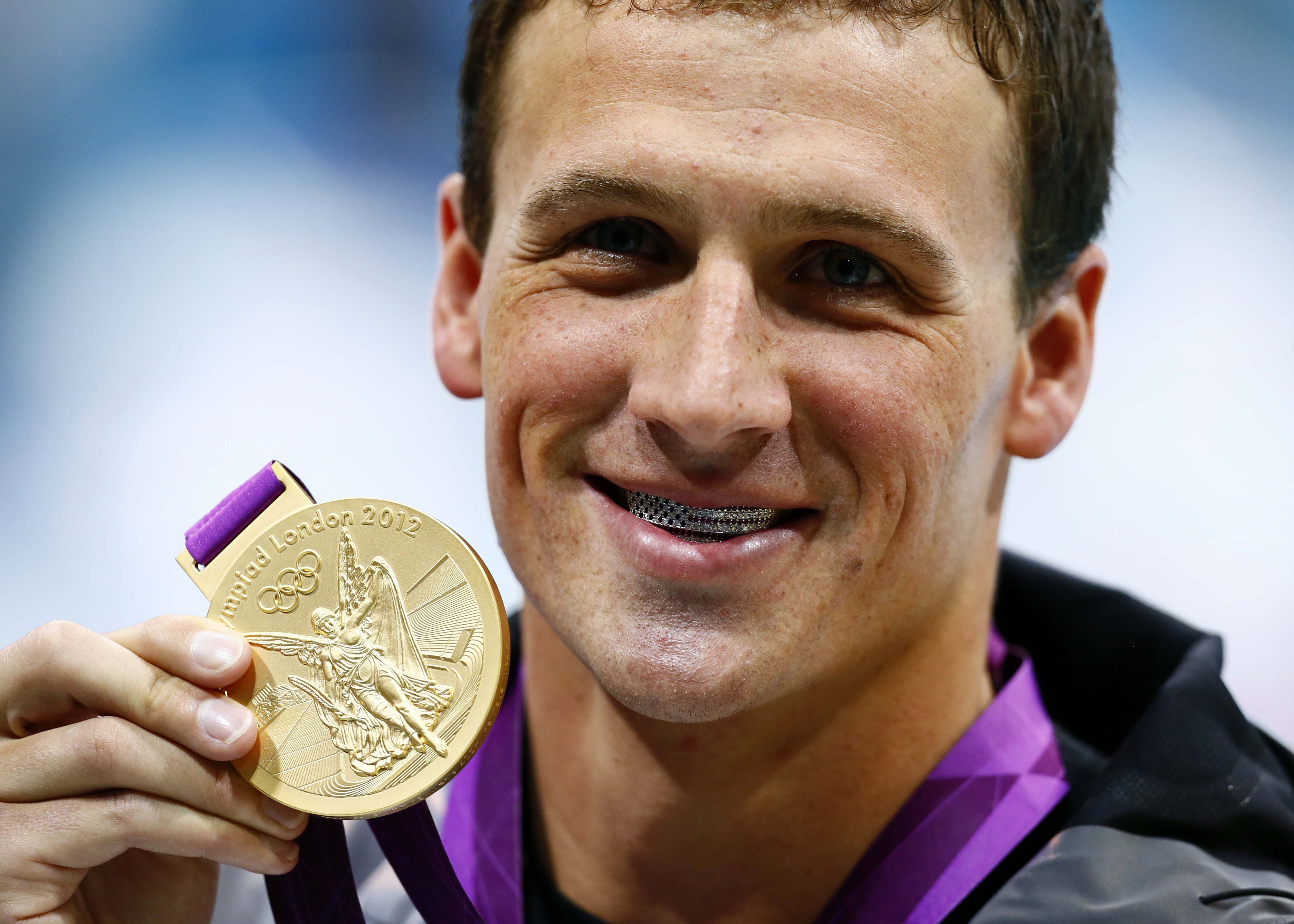 FYI *** THIS IS A SATURDAY NIGHT GOLD MEDAL *** ORG XMIT: USPW-GRP-4 Jul 28, 2012; London, United Kingdom; Ryan Lochte (USA) poses with his gold medal after winning the 400m individual medley finals during the 2012 London Olympic Games at Aquatics Centre. Mandatory Credit: Rob Schumacher-USA TODAY Sports ORIG FILE ID: 20120728_jel_usa_106.jpg
