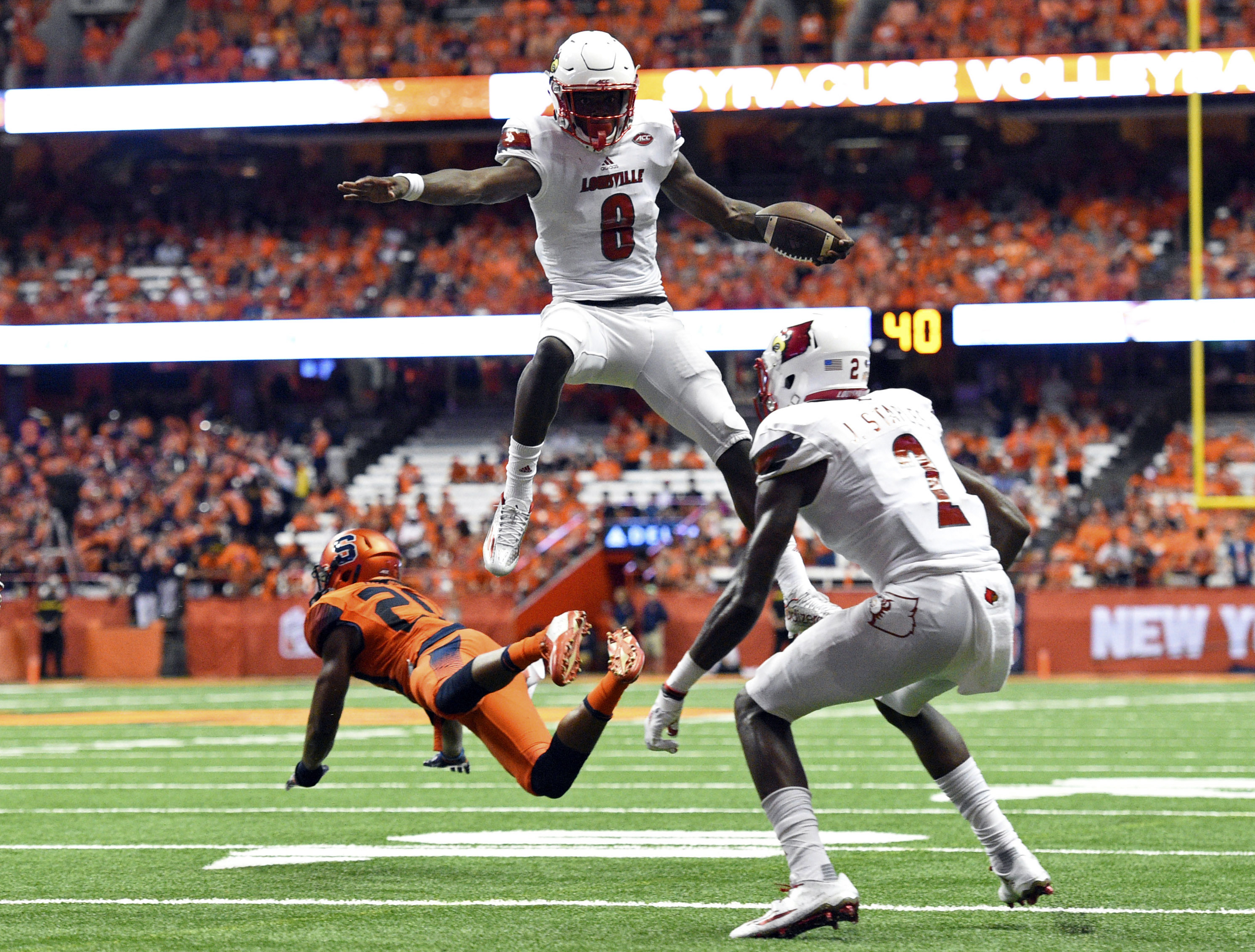 Louisville QB Lamar Jackson leaps over defender for 5th touchdown