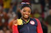 Aug 16, 2016; Rio de Janeiro, Brazil: Simone Biles (USA) celebrates after winning a gold medal during to the women's floor exercise final in the Rio 2016 Summer Olympic Games at Rio Olympic Arena. Mandatory Credit: Robert Deutsch-USA TODAY Sports ORG XMIT: USATSI-GRP-950 ORIG FILE ID: 20160816_ads_usa_397.JPG