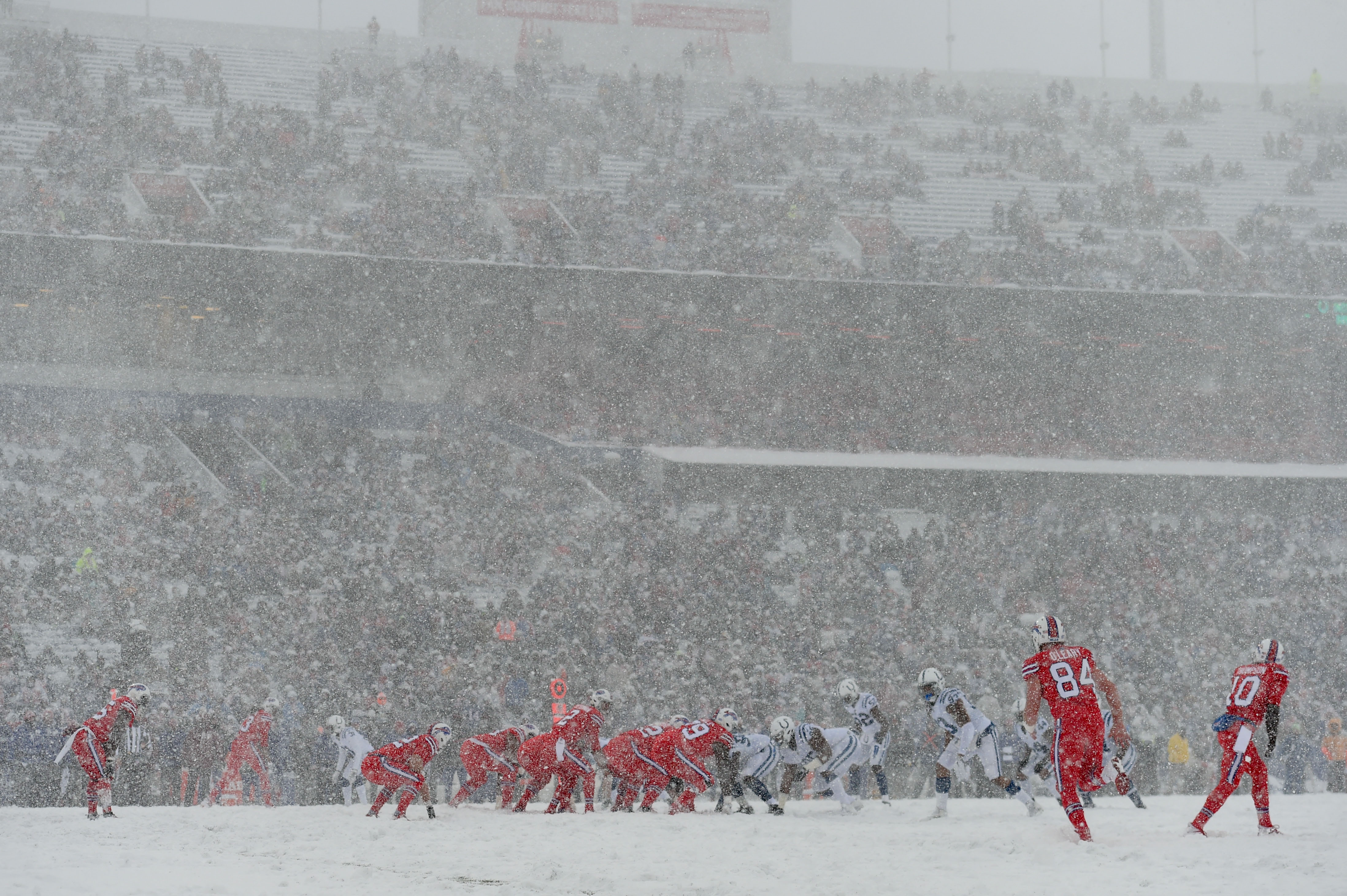 Snow covered Colts vs. Bills game action photos